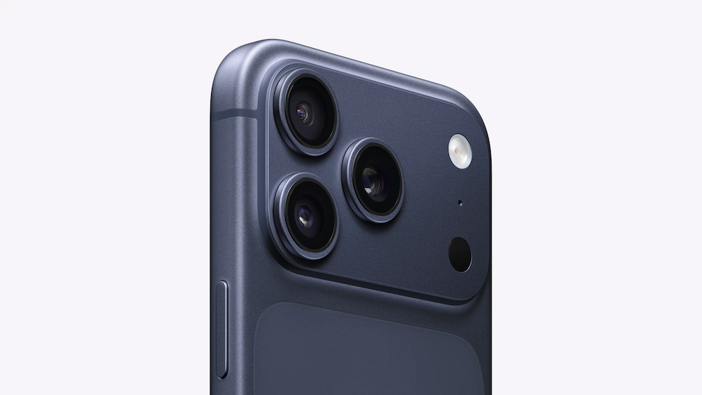 iPhone 17 Pro: A Global Review of its Groundbreaking Features 3 A detailed photo of a professional photographer using the iPhone 17 Pro to capture a distant subject, highlighting the phone's 8x optical zoom and the new triple 48MP camera system.